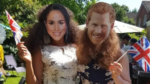 Sabrina and Olivia in Meghan Markle and Prince Harry masks.