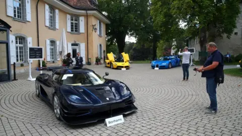 Reuters Luxury cars are displayed at an auction in the Swiss village of Cheserex, near Geneva
