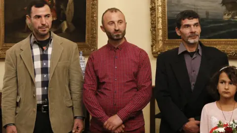 Getty Images Migrant fishermen at Greek citizenship ceremony, 2 Jan 19