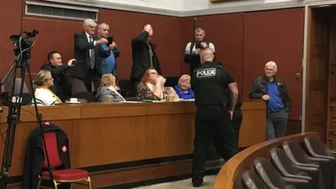 LDRS Police officers speaking to members of the public in the gallery of the council chamber