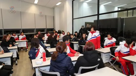 Getty Images North Korean and South Korean women's ice hockey players meet at a training centre ahead of the Games