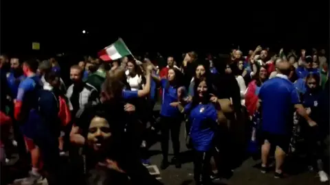 Italian fans celebrate in Bedford