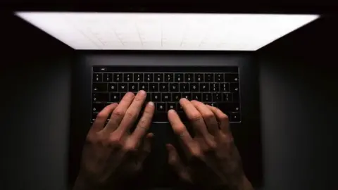Getty Images fingers on laptop