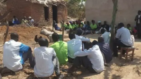 Tiyeni Fund/States of Guernsey Farmers listening to a lesson