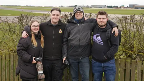 Oli Constable/BBC A group of friends at the airfield