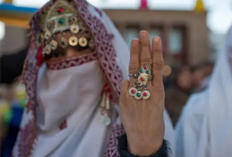 EPA An Amazigh woman wears traditional clothes on the eve of the 2969th Amazigh New Year near the parliament in the capital of Rabat, Morocco, 12 January 2019. After more than eight years of devoting Berbers as an official language alongside Arabic, voices in Morocco are increasingly calling for a public holiday to celebrate the Berber New Year.