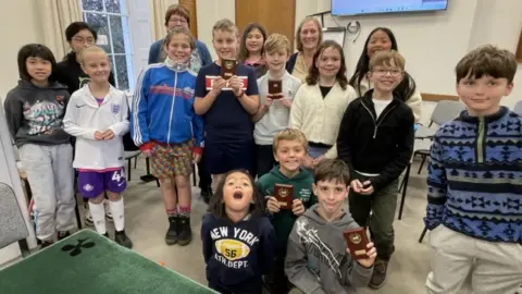 Ro Kaye A group of young Bridge players, some holding medals