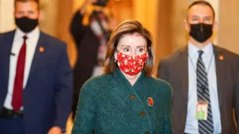 Getty Images Speaker of the House Nancy Pelosi (D-CA) heads back to her office after she opened up the House floor on December 28, 2020 in Washington, DC