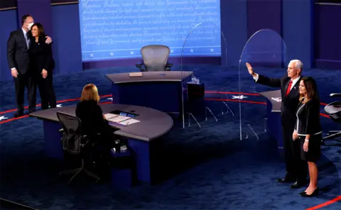 Reuters Kamala Harris and Mike Pence leave the stage after the Vice President debate