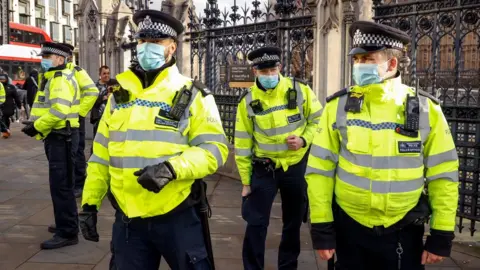 Reuters Police officers stand at Parliament Square during an anti-lockdown protest