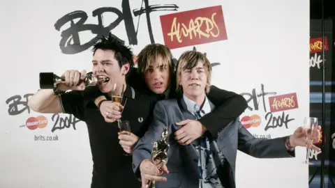 Getty / JMEnternational Busted's Matt Willis, Charlie Simpson and James Bourne holding their Brit awards