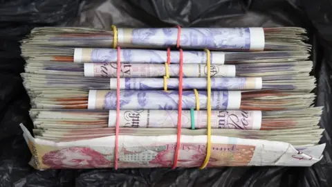 Devon and Cornwall Police Some of the money seized from the gang