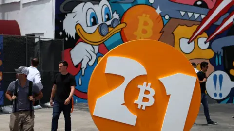 Getty Images People enjoy themselves at the Bitcoin 2021 Convention, a crypto-currency conference in Miami