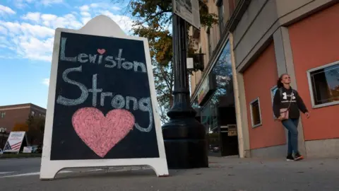 Getty Images A Lewiston Strong sign is seen after two mass shootings on October 27, 2023 in Lewiston, Maine.