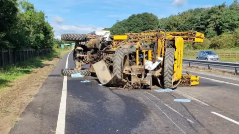 The overturned tractor on the A69