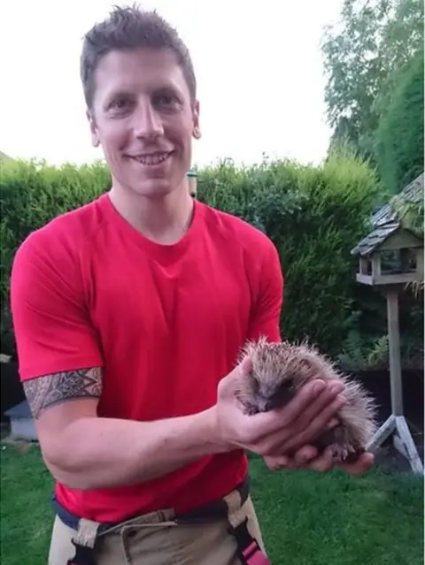 Staffordshire Fire and Rescue Service  Mitch Stafford with rescued hedgehog