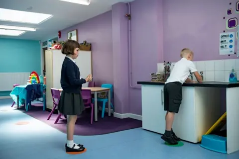 PA Media May 18, 2020 - Children abide by a traffic light system for social distancing when washing their hands at Kempsey Primary School in Worcester. Nursery and primary pupils could return to classes from June 1 following the announcement of plans for a phased reopening of schools.