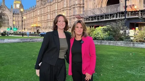 BBC / David Macmillan MP Lola McEvoy stood outside the houses of parliament with Ellen Roome.