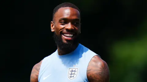 PA Media Closeup of Ivan Toney in a blue sleeveless training vest with the England crest on it. 