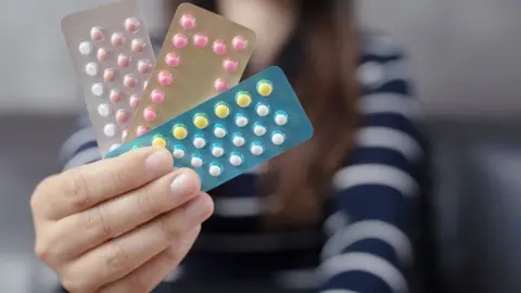 Getty Images Women holding birth control pills