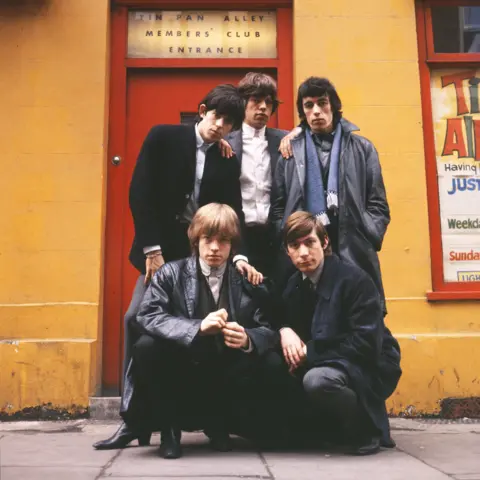 Terry O'Neill / Iconic Images Terry O'Neill CBE shot of The Rolling Stones who line up outside the Tin Pan Alley Club in London, 1963