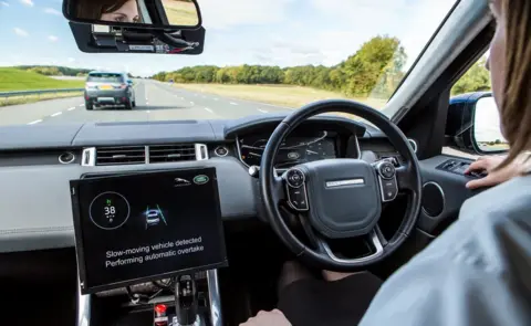 Jaguar Land Rover A screen showing that the car is about to overtake a vehicle in front