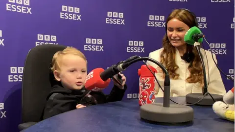 Lauren Carter/BBC Jesse and Chloe in a BBC Essex radio studio