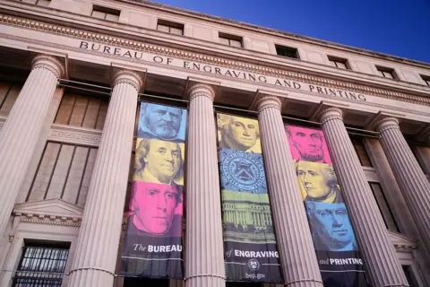 Banners hang from the front of the Bureau of Engraving and Printing headquarters building on January 19, 2026, in Washington, DC