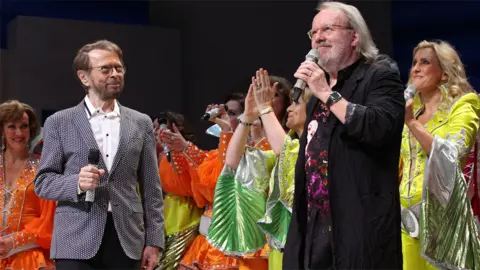 PA Bjorn Ulvaeus (left) and Benny Andersson on stage with Mamma Mia cast members at the Novello Theatre, London