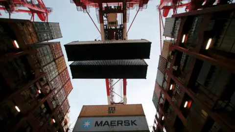 Reuters Containers being unloaded