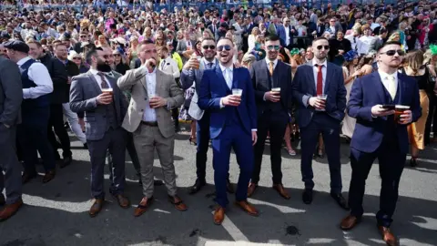 PA Media Men posing for a picture at Aintree