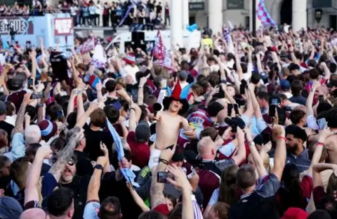 PA A sea of Aston Villa fans with their arms aloft