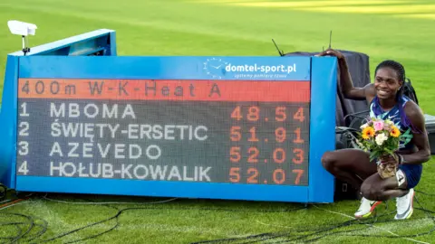 EPA Namibian Christine Mboma posing next to a sign showing her record-breaking time for the the under-20 women's 400m race in Bydgoszcz, Poland - Wednesday 30 June 2021