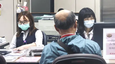 Getty Images Bank tellers at a bank in Tapei