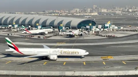 Reuters Emirates plane on tarmac at Dubai International