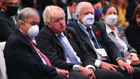 Getty Images Boris Johnson sat without a mask next to Sir David Attenborough at COP 26