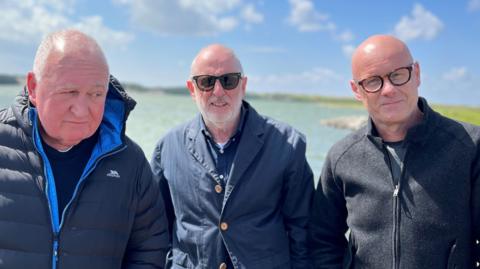 Paul Carter, Steve Boulton and Dickie Felton standing by the coast