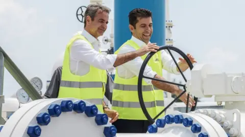 Getty Images Greek Prime Minister Kyriakos Mitsotakis (L) and his Bulgarian counterpart Kiril Petkov take part in the inauguration ceremony of the Interconnector Greece-Bulgaria (IGB) gas pipeline, in Komotini, northern Greece, on July 8, 2022.