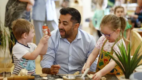 PA Media Humza Yousaf at a nursery