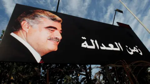 Reuters (File photo) A billboard showing former Lebanese Prime Minister Rafik Hariri and the slogan "Time for justice" is displayed on a street in Beirut, Lebanon (16 January 2014)