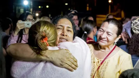 EPA Maria Perez hugs her family after her release