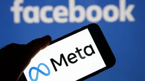 Chesnot/Getty Images In this photo illustration, the Meta logo is displayed on the screen of an iPhone in front of a Facebook logo on October 29, 2021