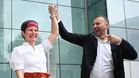 Getty Images Green leader Zack Polanski celebrates with Zoë Garbett in Hackney