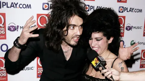 Getty Images Singer Amy Winehouse and TV presenter Russell Brand pose in the awards room at the Q Awards 2006 at Grosvenor House Hotel on October 30, 2006 in London