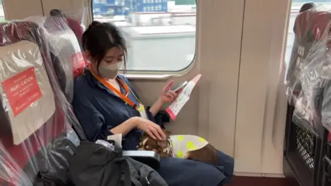 AFP Yukari Seino with her pet chihuahua