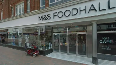External view of M&S in St Mary's Street with a mobility scooter parked outside