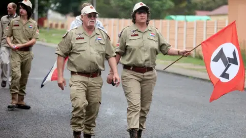 AFP Supporters of the white supremacist Afrikaans Resistance Movement (AWB) arrive on November 22, 2010 at the Ventersdorp magistrate court for the trial of a 15-year-old minor and his co-accused Chris Mahlangu, 28, charged with hacking to death the 69-year-old leader of the AWB, Eugene Terre'Blanche, in April.