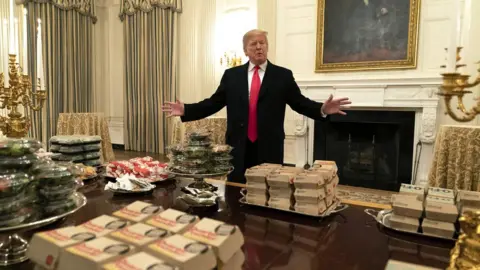 EPA US President Donald Trump presents fast food to be served to the Clemson Tigers football team