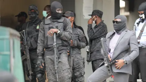 Mansur Ibrahim Armed men in balaclavas