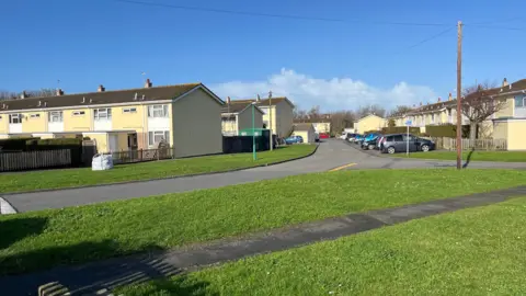 Les Genats Housing Estate - lines of yellow houses around some roads. 